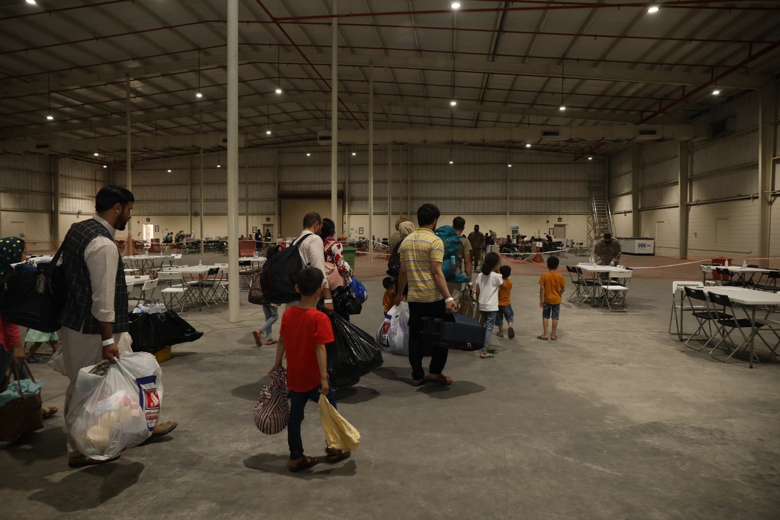 As Airstrikes Loom, Hundreds of Afghan Refugees Still Stranded at U.S. Base in Qatar